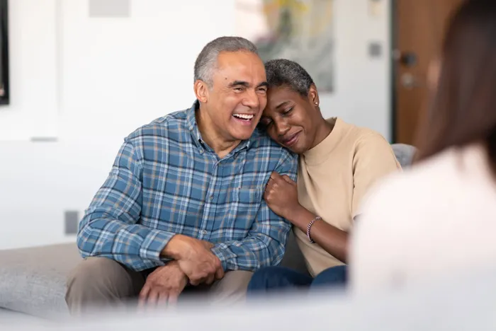 An older couple sharing a warm, comforting moment together at home
